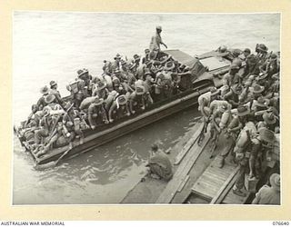 LAE, NEW GUINEA. 1944-11-02. TROOPS OF THE 14/32ND INFANTRY BATTALION ARRIVING IN DUKWS AT THE PONTOON ALONGSIDE THE TROOPSHIP, "CAPE ALEXANDER" PRIOR TO THEIR EMBARKATION