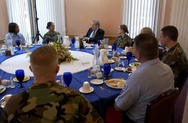 The Honorable Donald H. Rumsfeld (back-center), U.S. Secretary of Defense, talks with the troops during lunch in the Magellan Hall Dining Facility at Andersen Air Force Base, Guam, on Nov. 14, 2003. (DoD photo by TECH. SGT. Andy Dunaway) (Released)