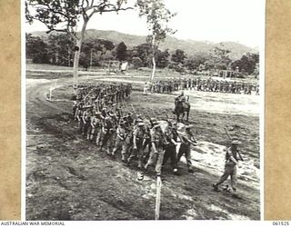 POM POM VALLEY, NEW GUINEA. 1943-11-30. 2/12TH AUSTRALIAN INFANTRY BATTALION, MARCHING OFF THE SHOWGROUND AFTER AN INSPECTION BY THEIR COMMANDING OFFICER QX6008 LIEUTENANT COLONEL C. C. F. BOURNE. ..