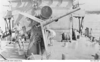 ORO BAY, PNG, 1943-04-11. A 12-POUNDER GUN ON THE DECK OF HMAS PIRIE, SHOWING DAMAGE CAUSED BY CANNON FIRE. (DONOR J. LYALL)