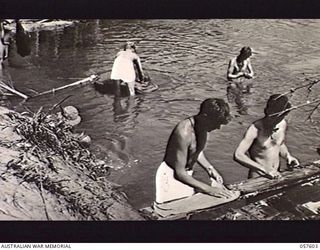 SALAMAUA AREA, NEW GUINEA. 1943-09-20. TROOPS OF THE 162ND INFANTRY REGIMENT, 41ST UNITED STATES DIVISION CLEANING UP IN THE RIVER. THIS UNIT HAS BEEN FIGHTING IN THE TAMBU AREA AND WERE IN AT THE ..