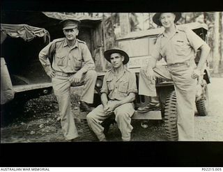 Milne Bay, New Guinea. 1943-06. Left to right: Lieutenant Sol Cohen, Private Matt Carroll and Australian Red Cross representative Stan Chilton posing in front of a Red Cross jeep