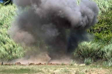 A large plumb of smoke rises into the air following the detonation of an explosive device at the Emergency Disposal Range, at the Naval Magazine, at Santa Rita Naval Base, Guam (GU), during the Annual Multi-national Explosive Ordnance Disposal (EOD) Exercise known as TRICARB 2006." US Navy (USN), Royal Australian Navy (RAN), and Royal Singapore Navy (RSA) Explosive Ordnance Disposal (EOD) personnel came together to participate in the training event