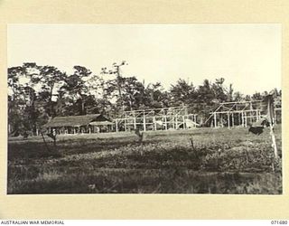 LAE, NEW GUINEA. 1944-03-25. ONE OF ADJOINING PHOTOGRAPHS SHOWING THE OFFICERS' MESS, OFFICERS' QUARTERS AND QUARTERS UNDER CONSTRUCTION AT HEADQUARTERS LAE BASE SUB-AREA. THE RECREATION GROUND IS ..