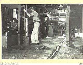 PORT MORESBY, NEW GUINEA. 1944-04-18. THE ENGINE ROOM IN THE FREEZING PLANT AT THE NO. 1 COLD STORE, AUSTRALIAN ARMY SERVICE COMPANY AT ELA BEACH. MACHINERY AT THE PLANT IS OPERATED BY THE 8TH ARMY ..