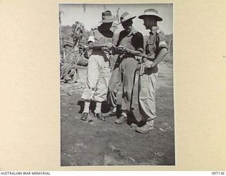 MALAGUNA BEACH, RABAUL, NEW BRITAIN. 1945-09-21. CAPTAIN B. MCK. SHANKS, PRINCIPAL MILITARY LANDING OFFICER AND BEACHMASTER, 13 BRIGADE BEACH GROUP (1) AND HIS ASSISTANTS LIEUTENANT K.C. FORSYTH ..