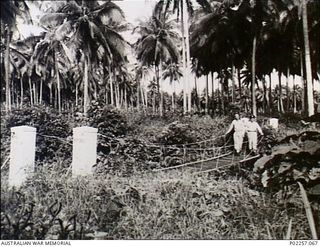 Madang, New Guinea, c. 1944. Flight Lieutenant Wal ('The Nose') Waldie (left) and Gordon Thomas, both serving with Headquarters, RAAF Northern Command (NORCOM), stand on a suspension bridge ..