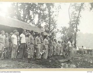 MALMAL MISSION, JACQUINOT BAY, NEW BRITAIN. 1944-11-24. TROOPS OF B COMPANY, 594TH ENGINEER BOAT AND SHORE REGIMENT, UNITED STATES ARMY ATTACHED TO THE 5TH AUSTRALIAN DIVISION LINE UP FOR THEIR ..
