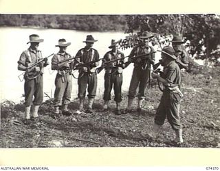 SIAR, NEW GUINEA. 1944-06-25. TROOPS OF A COMPANY, 57/60TH INFANTRY BATTALION RECEIVING INSTRUCTION IN THE HANDLING AND MAINTENANCE OF THE OWEN GUN. IDENTIFIED PERSONNEL ARE:- VX113653 CORPORAL G. ..