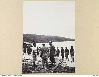 MUSCHU ISLAND, NEW GUINEA, 1945-09-09. LIEUTENANT T.W.J. LEGA, AUSTRALIAN NEW GUINEA ADMINISTRATIVE UNIT OFFICER ATTACHED TO 6 DIVISION WITH A COLLEAGUE, IN A DISCUSSION WITH THE FORMER JAPANESE ..