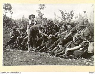 ALEXISHAFEN, NEW GUINEA. 1944-05-17. MEMBERS OF NO. 14 PLATOON, C COMPANY, 35TH INFANTRY BATTALION BEING QUESTIONED BY THEIR PLATOON COMMANDER AFTER RETURNING TO COMPANY HEADQUARTERS FROM A PATROL ..