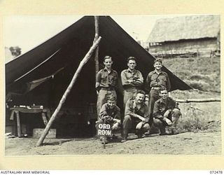 DUMPU, NEW GUINEA. 1944-04-19. MEMBERS OF THE ORDERLY ROOM STAFF OUTSIDE THEIR OFFICE, HEADQUARTERS 15TH INFANTRY BRIGADE. IDENTIFIED PERSONNEL ARE:- V127049 CORPORAL W.T. PASCOE (1); VX139886 ..