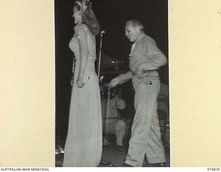 LAE, NEW GUINEA. 1944-07-24. CAROL LANDIS (1) AND JACK BENNY PLAYING A SKIT DURING A CONCERT STAGED FOR THE TROOPS BY THE JACK BENNY SHOW