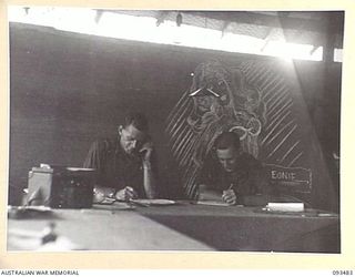 WEWAK AREA, NEW GUINEA. 1945-06-28. WARRANT OFFICER 2 G.A. BROWN (1) AND PRIVATE L. FRYER, HIS CLERK (2) IN THE OFFICE AT THE FIELD MAINTENANCE CENTRE, ASSISTANT DIRECTOR OF ORDNANCE SERVICE DUMP, ..