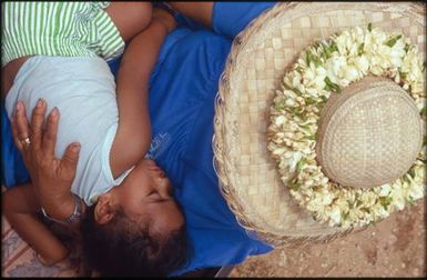 Woman in hat holding child, Mangaia