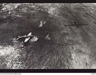 BORAM, NEW GUINEA. ? 1944-03. PARKED JAPANESE AIRCRAFT ON THE AIRSTRIP UNDER ATTACK BY MITCHELL B25 BOMBER AIRCRAFT OF FIFTH AIR FORCE, UNITED STATES ARMY AIR FORCE