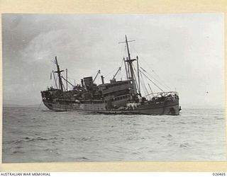 OFF PORT MORESBY, PAPUA. 1942-08-30. THE M.V. MALAITA SHORTLY AFTER SHE HAD BEEN TORPEDOED BY AN ENEMY SUBMARINE OFF PORT MORESBY ONLY ONE CASUALTY WAS SUSTAINED - THE CHIEF STEWARD WITH TWO BROKEN ..