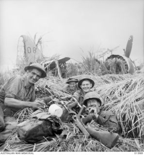 1942-12-05. PAPUA. ALLIES ATTACK BUNA. ONE OF THE ZERO FIGHTER AIRCRAFT HIT BY THE ALLIED AIR FORCE ON THE AIR STRIP AT BUNA. THESE WERE THE FIRST PICTURES EVER TAKEN OF THE NEW TYPE OF ZERO ..