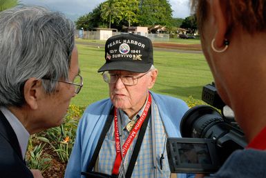 U.S. Navy Pearl Harbor survivor William Bob Johnson answers questions from the Japanese news agency Asahi Broadcasting on Ford Island, on Dec. 3, 2006, near the USS UTAH Memorial. He explains his location and the role on Ford Island during the 1941 attack on Pearl Harbor, Hawaii. The UTAH was hit by three aerial torpedoes and sank during the attack. (U.S. Navy PHOTO by Mass Communication SPECIALIST SEAMAN Daniel A. Barker) (Released)