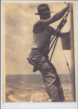Man painting the hull of a ship, Pacific Ocean, 1934 / Sarah Chinnery