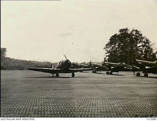 TOROKINA, BOUGAINVILLE ISLAND, SOLOMON ISLANDS. 1945-01-15. AN AUSTRALIAN BUILT BOOMERANG AIRCRAFT OF NO. 5 (ARMY CO-OPERATION) SQUADRON RAAF ON PIVA AIRFIELD TAXIES PAST ROYAL NEW ZEALAND AIR ..