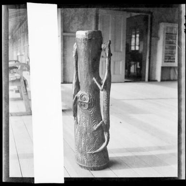 Hand drum with carved crocodile handles, on a verandah, Awar [?], Sepik River, New Guinea, 1935 / Sarah Chinnery