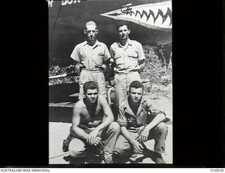 PORT MORESBY, PAPUA. C. 1943. RAAF AND USA AIRMEN WHO FLY TOGETHER AS THE CREW OF AN AMERICAN B-25 MITCHELL BOMBER AIRCRAFT. RAAF MEMBER IDENTIFIED BY WEARING OF WINGS INSIGNIA OVER LEFT BREAST