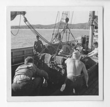 [Men Pushing a Jeep on Board a Boat]