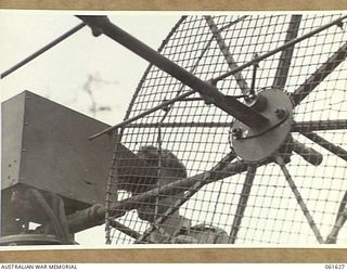 PORT MORESBY, NEW GUINEA. 1943-12-16. AN OPERATOR WORKING ON THE (SEARCHLIGHT CONTROL) SITE TESTING EQUIPMENT AT THE HEAVY ANTI-AIRCRAFT GUN SITE H.8, ROYAL AUSTRALIAN ARTILLERY