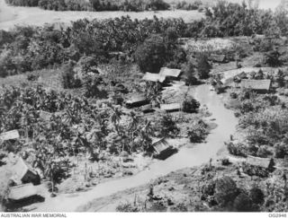 WEWAK, NORTH EAST NEW GUINEA. 1945. A FEW SECONDS AFTER THIS PHOTOGRAPH WAS TAKEN FROM A RAAF BEAUFORT BOMBER AIRCRAFT, THERE WAS LITTLE LEFT OF THIS NEW GUINEA VILLAGE WHICH WAS THE SUBJECT OF AN ..