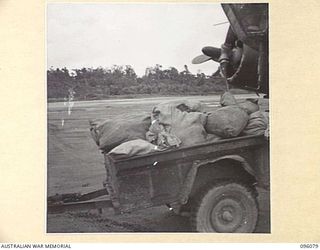 CAPE WOM, WEWAK AREA, NEW GUINEA. 1945-09-06. JEEP TRAILER LOADED WITH MAIL, ABOUT TO LEAVE THE BEAUFORT BOMBER WHICH BROUGHT MAIL TO THE AIRSTRIP. THE MAIL IS TRANSPORTED BY TRAILER TO THE BASE ..