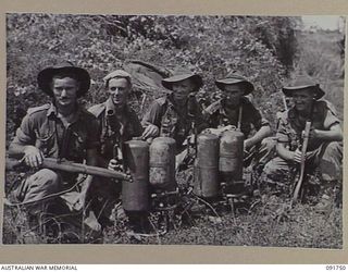 WEWAK AREA, NEW GUINEA, 1945-05-10. FLAME THROWER OPERATORS OF 2/4 INFANTRY BATTALION, GROUPED WITH THEIR WEAPONS. IDENTIFIED PERSONNEL ARE:- PTE W.A. BISHOP (2); PTE R.W. WHITNEY (3); PTE A.L. ..