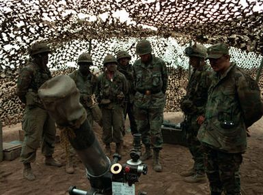 Brigadier General John Quinn (center) visits with members of the 4.2 mortar section of Combat Support Company, 1ST Battalion, 35th Infantry, 25th Infantry Division, during their annual artillery training exercise