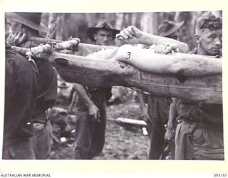 WEWAK AREA, NEW GUINEA, 1945-06-17. STRETCHER BEARERS CARRYING OUT CASUALTIES DURING THE ATTACK BY B COMPANY, 2/8 INFANTRY BATTALION, AGAINST HILL 2. IDENTIFIED PERSONNEL ARE:- WO 2 E. DAVIS (2); ..