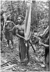 Pig festival, uprooting cordyline ritual, Tsembaga: men display large red pandanus fruits in ancestral shrine