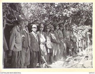 A LINE UP OF JAPANESE WOUNDED AND SICK ON NUMA NUMA BEACH FOR MEDICAL INSPECTION. MEMBERS OF THE AUSTRALIAN SURRENDER PARTY FROM HEADQUARTERS 2 CORPS HAVE ARRIVED AT NUMA NUMA PLANTATION TO DISCUSS ..