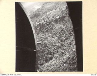 NEW GUINEA. 1945-05-06. RATIONS AND STORES, FOR UNITS OF 17 INFANTRY BRIGADE, SUPPLIED BY HEADQUARTERS COMMAND, AUSTRALIAN ARMY SERVICE CORPS, 6 DIVISION, BEING DROPPED FROM A 36 SQUADRON, RAAF ..