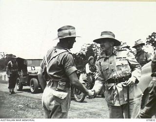 LAE, NEW GUINEA, 1944-03-08. VX20308 MAJOR-GENERAL F.H. BERRYMAN, CBE, DSO, (1), GENERAL OFFICER COMMANDING 2ND AUSTRALIAN CORPS, BEING GREETED BY QX6152 BRIGADIER R.F. MONOGHAN (2), BEFORE ..