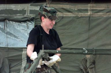 US Air Force SENIOR AIRMAN Roxanne Price from the 36th Civil Engineer Squadron, Andersen Air Force base, Guam, set up the frame of a tent being erected for airmen from the 96th Bomb Squadron and support personnel from the 2nd Bomb Wing, Barksdale Air Force Base, Louisiana. The airmen are being deployed to Naval Station Diego Garcia in support of Operation DESERT THUNDER 2