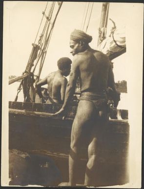 Man standing beside Wauchope's schooner the Balangot, Awar, Sepik River, New Guinea, 1935 / Sarah Chinnery