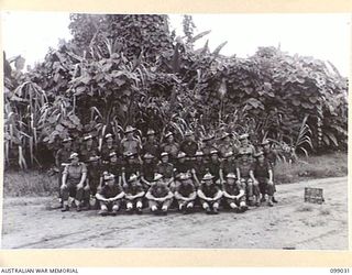 Group portrait of the personnel of 121 Supply Depot Platoon, 30 Advanced Supply Depot. Left to right, back row: N265771 Private (Pte) C C Kemp of Corrimal, NSW; V56383 Pte H J Carey of Footscray, ..