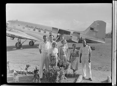 Qantas Lae office staff, P Shanler, senior traffic officer, Miss A Armitage, secretary, (front) Mr G Watte, traffic officer, Mr I Little, traffic officer, Miss J Voysey, typist, Miss M Walker, typist, Mr H Hinwood, area manager for Papua New Guinea