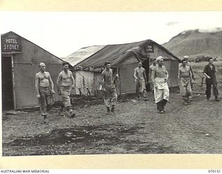 DUMPU, NEW GUINEA. 1944-02-05. PERSONNEL OF 15TH INFANTRY BRIGADE BAKERY, OUTSIDE THE LIVING QUARTERS. THE QUARTERS ARE GIVEN THE NAMES OF PROMINENT CITY HOTELS