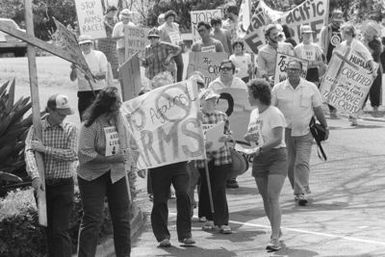 Anti-nuclear demonstrators parade in front of the main gate of the base