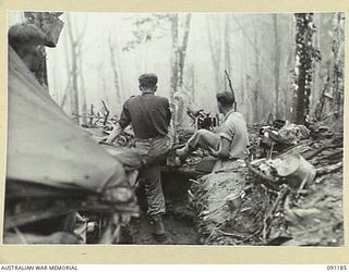 NUMA NUMA TRAIL, BOUGAINVILLE. 1945-04-24. A MACHINE GUN CREW OF 27 INFANTRY BATTALION EMPLACED ON HUNT'S OUTPOST. THIS WAS PART OF THE FIRST ACTION FOR THE BATTALION ON COMPLETION OF ITS TRAINING ..