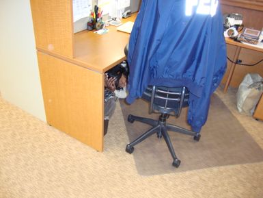 Fort Shafter, Hawaii, Oct. 18, 2012 -- FEMA Region IX employees in the Hawaii office practice "drop, cover, and hold on" during ShakeOut