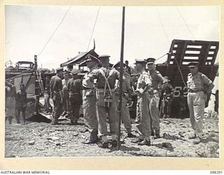 MALAGUNA MISSION, NEW BRITAIN. 1945-09-10. ARMY AND NAVY OFFICERS WATCHING OPERATIONS ON THE BEACH DURING THE FIRST DAY OF THE OCCUPATION OF THE RABAUL AREA, BY 4 INFANTRY BRIGADE TROOPS. THE GROUP ..