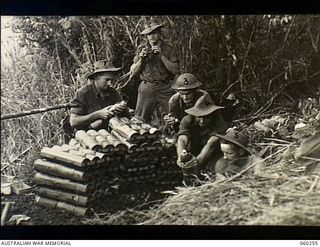 Faria River Area, New Guinea. 1943-11-07. A three inch mortar detachment of the 2/27th Australian Infantry Battalion providing supporting fire for the Battalion's C Company which was preparing to ..