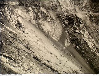 Bulldog, New Guinea. 1943-08-22. A rock face a few miles on the Bulldog side of Johnson's Gap which was difficult to overcome during construction of the Reinhold Highway by sappers of 9th ..