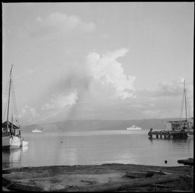 Anchored vessel and a jetty with moored ships and HMAS Australia [?], Rabaul Harbour, New Guinea, 1937 / Sarah Chinnery